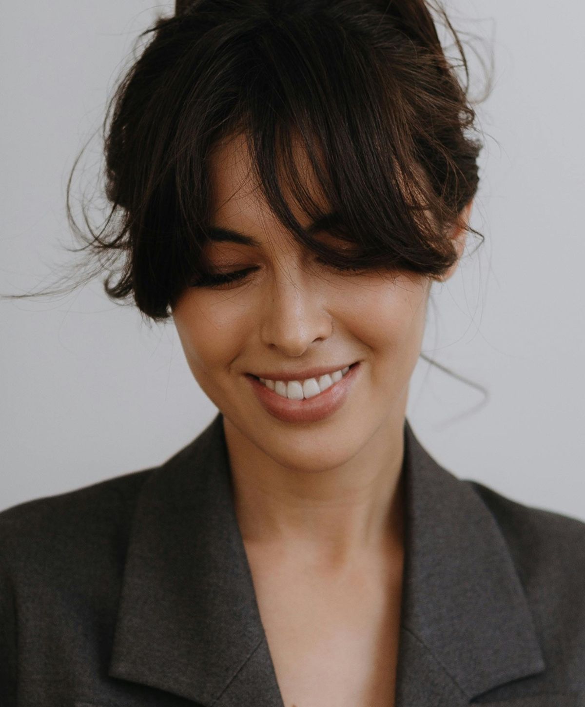 Woman with long hair looking back over shoulder.