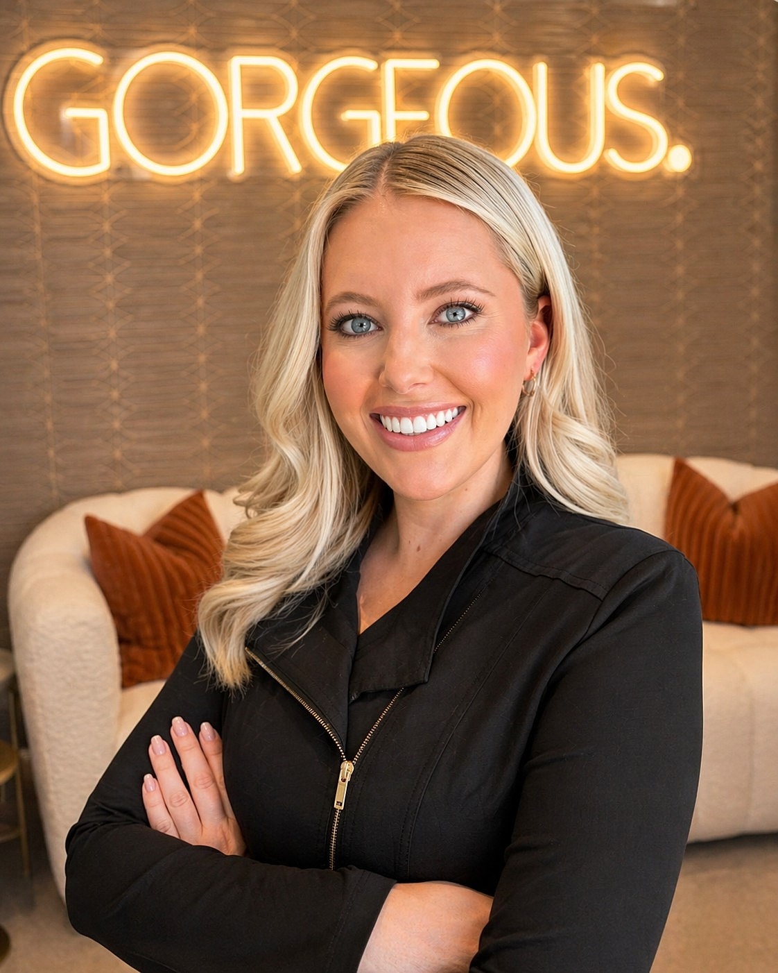 Smiling woman in a stylish interior setting.