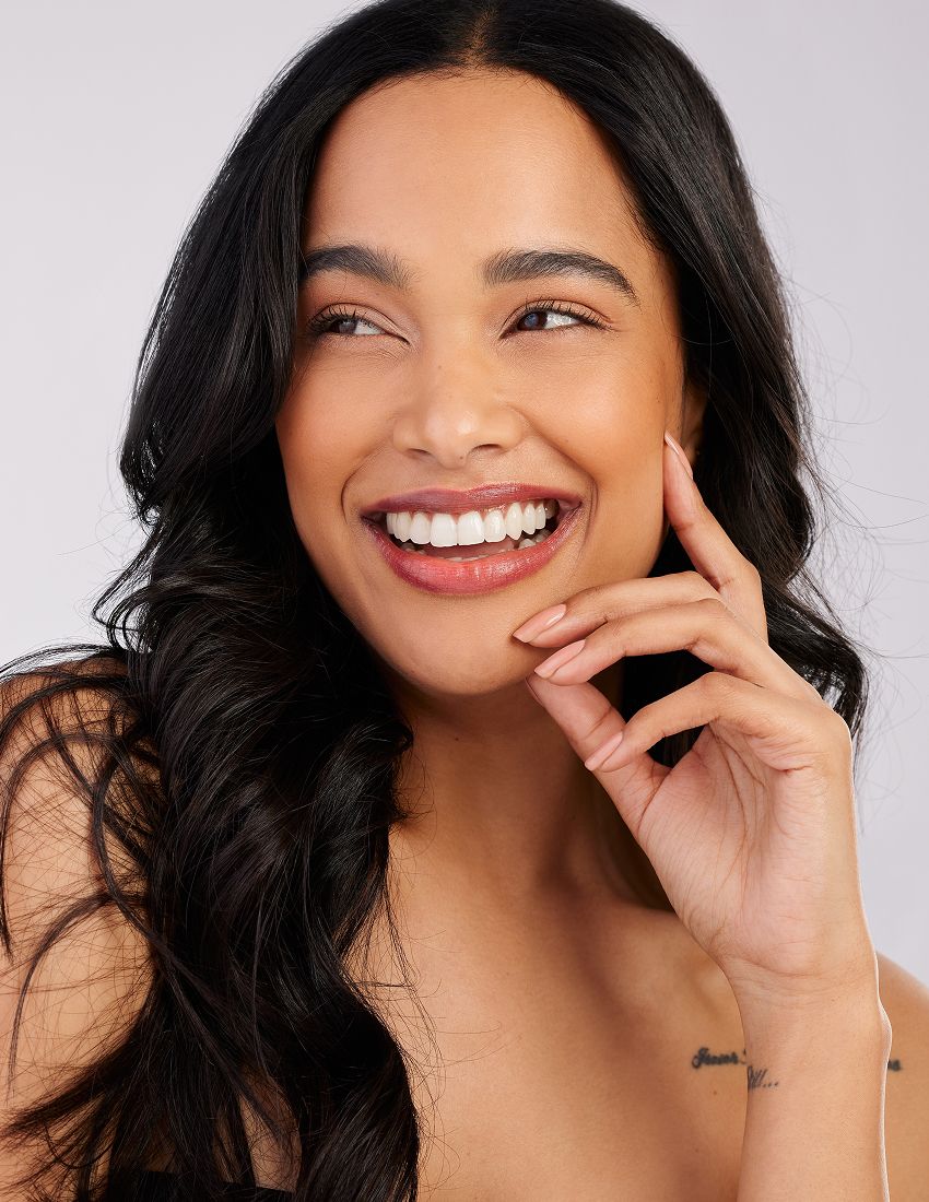 Smiling woman with long, wavy hair.