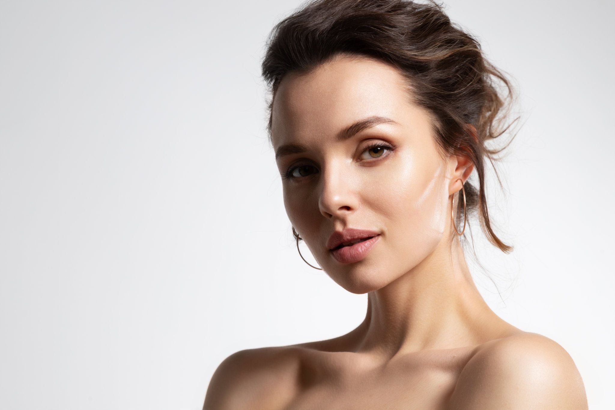 Woman looking upwards with thoughtful expression.