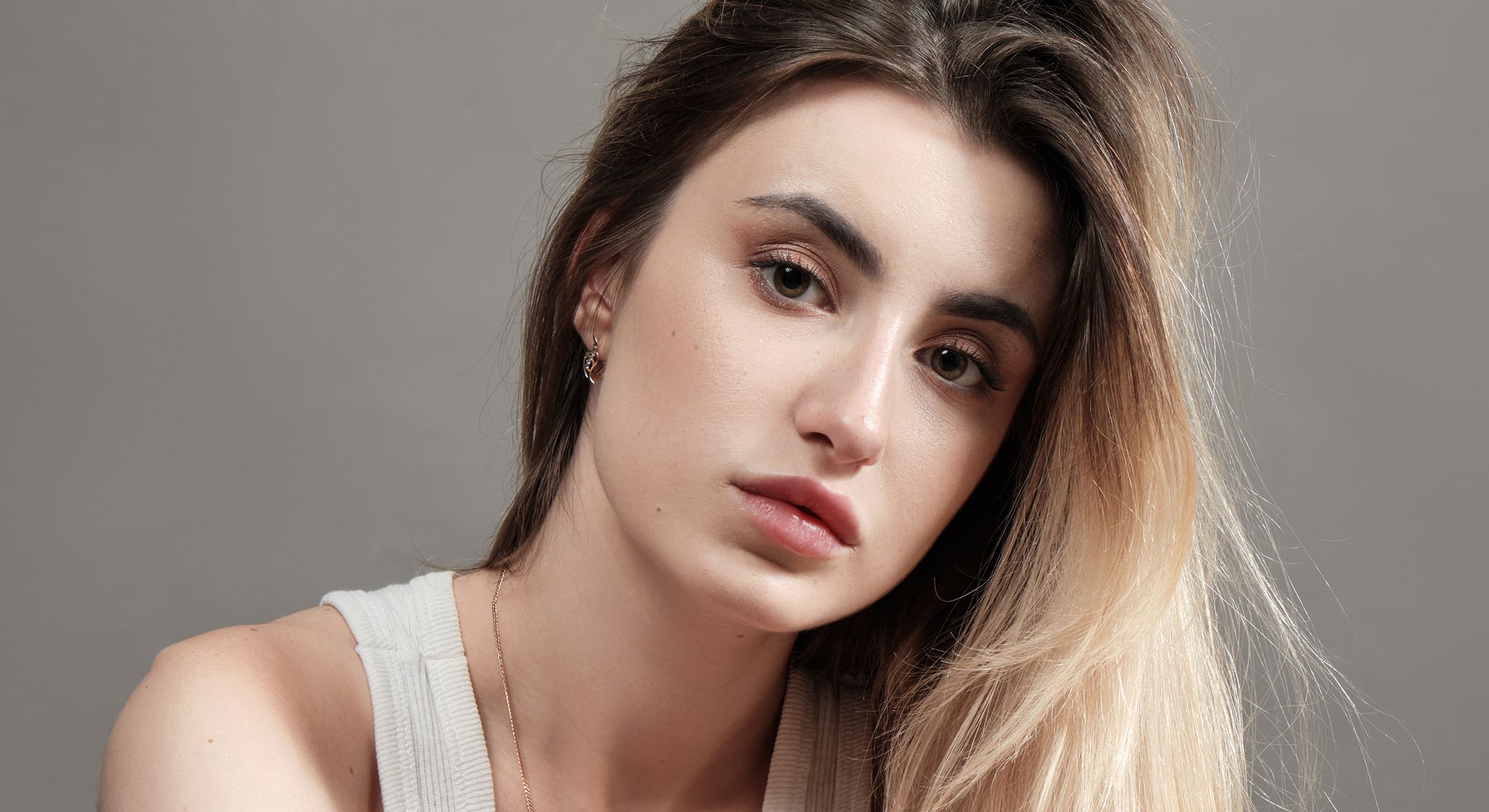 Woman with long hair and natural makeup.