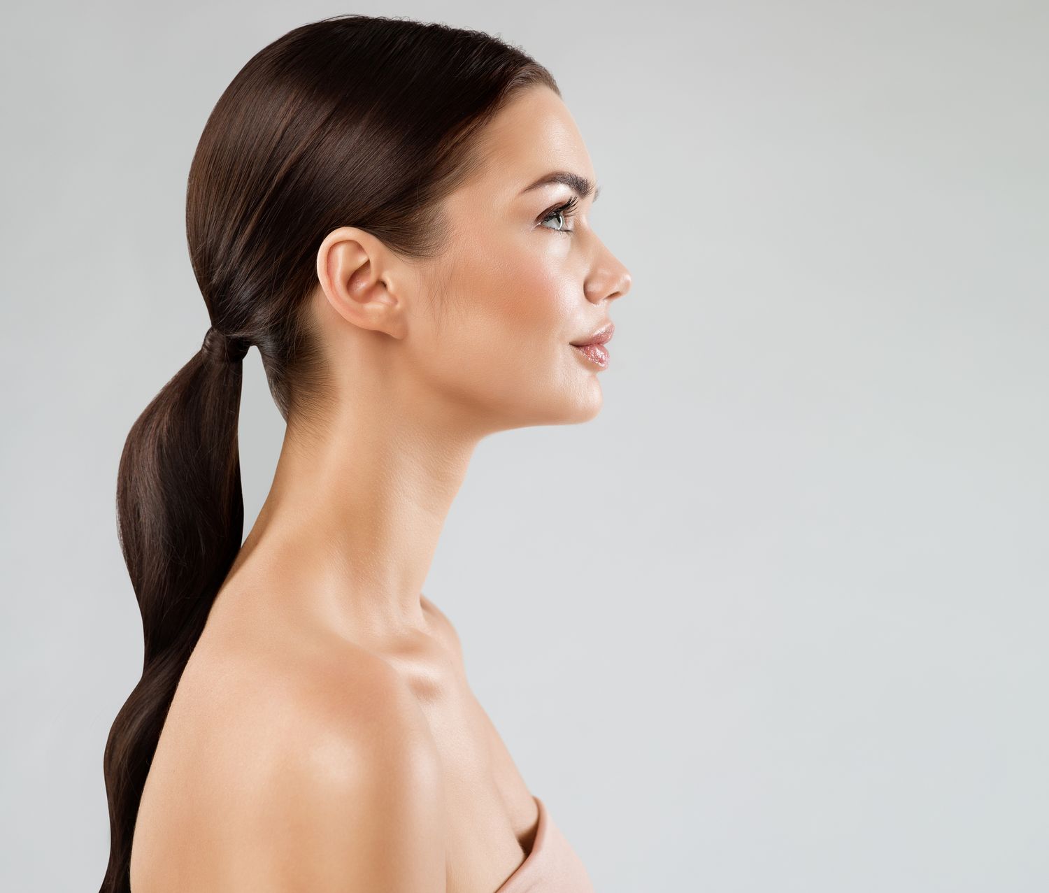 Woman with long hair in front of mirror.
