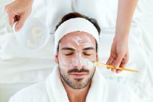 Relaxed man during facial treatments